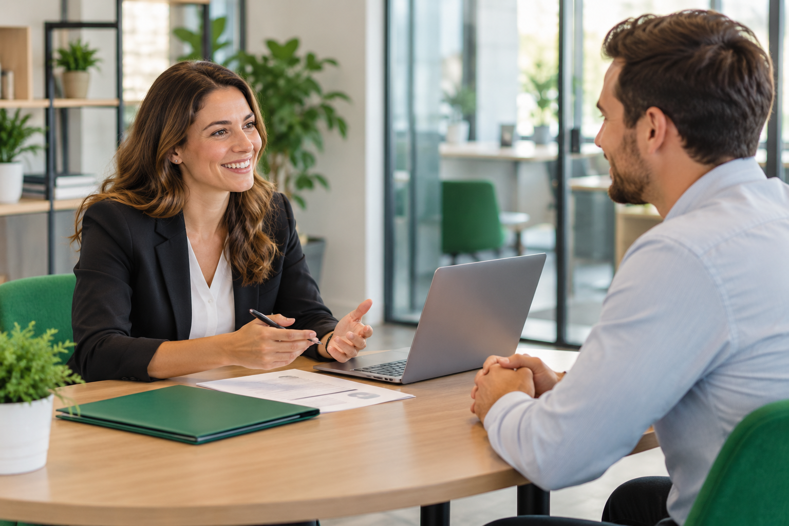 A recruiter and candidate having a professional conversation across an office table