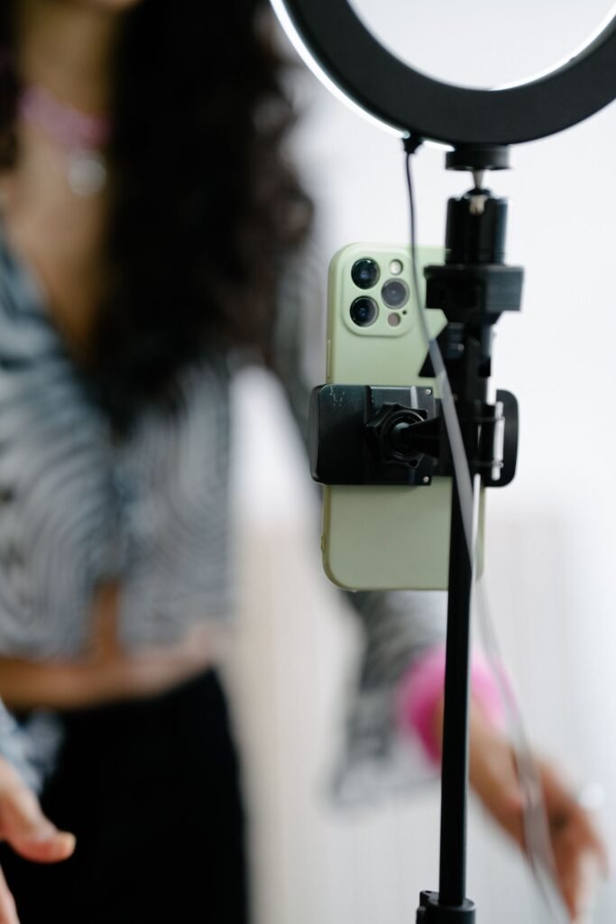 Creator recording content with a smartphone and ring light